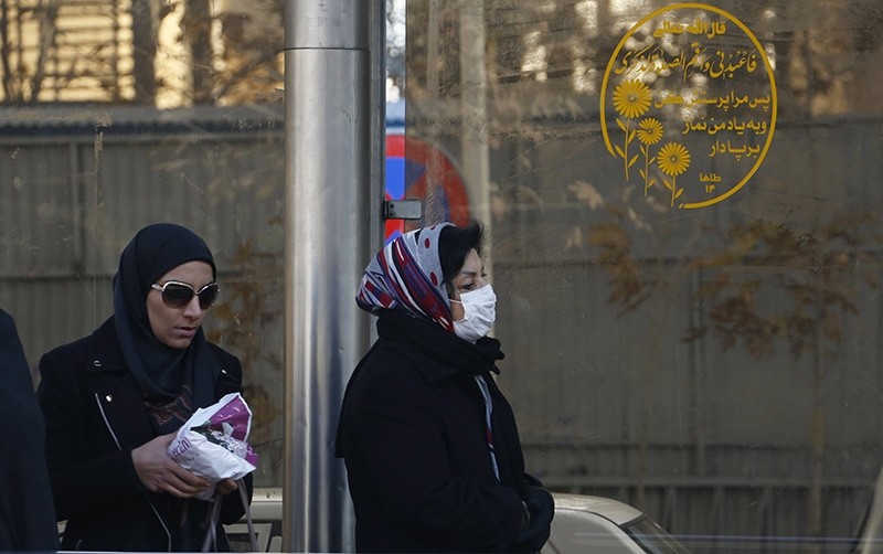 An Iranian woman wears a mask as she walks on a street in Tehran, Iran, Dec. 17 2017. (EPA Photo)