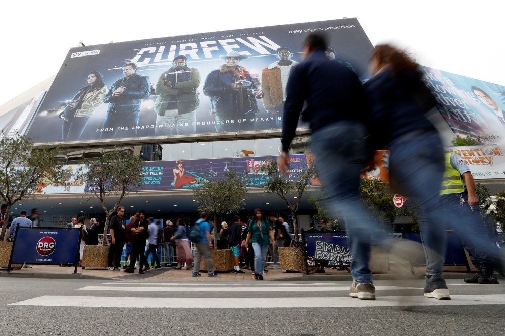 Visitors walk to the Festival Palace to attend the annual MIPCOM television program market in Cannes, France, Oct. 15, 2018.