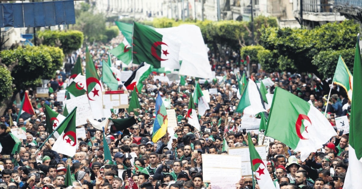 Demonstrators hold flags and banners as they return to the streets to press demands for wholesale democratic change well beyond former President Abdelaziz Bouteflika's resignation, in Algiers, Algeria, April 19, 2019.