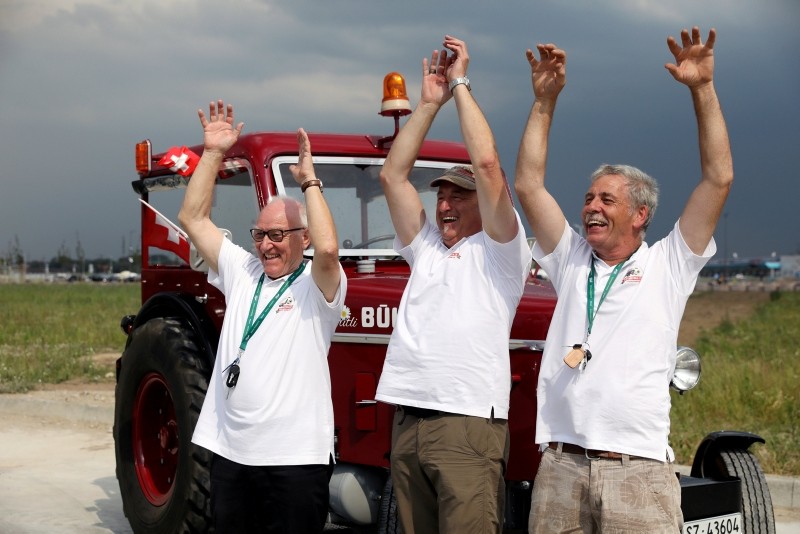 Swiss fans Josef Wyer, Beat Studer and Werner Zimmermann celebrate after driving an old-time tractor from home to Kaliningrad stadium to watch their team playing against Serbia, in Kaliningrad, Russia. (Reuters Photo)