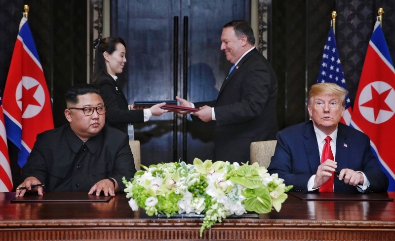 A document being exchanged between U.S. Secretary of State Mike Pompeo (2-R) and the Korean leader's sister Kim Yo Jong (2-L) moments after it was signed by President Trump and North Korean Chairmain Kim Jong-Un. (EPA Photo)