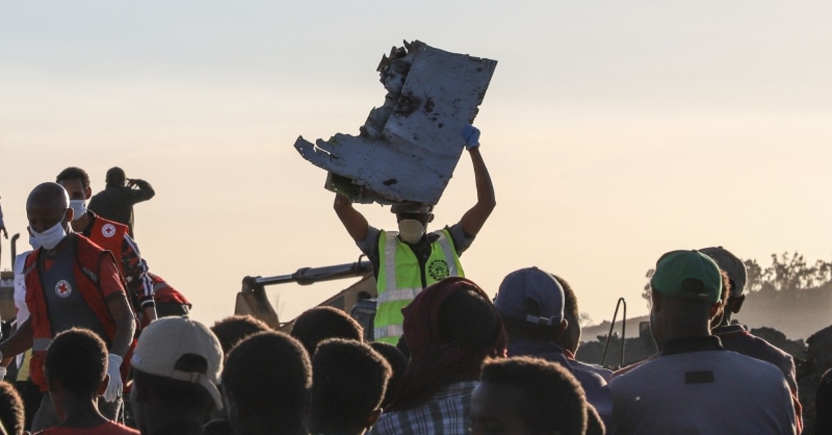 A man carries a piece of debris on his head at the crash site of a Nairobi-bound Ethiopian Airlines flight near Bishoftu, a town some 60 kilometers southeast of Addis Ababa, Ethiopia, March 10, 2019. (AFP Photo)