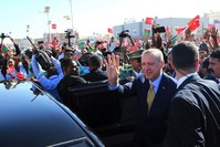 Turkish and Mauritanian security and people surround the car of President Erdou011fan as he waves during a welcoming ceremony at the airport in Nouakchott, Mauritania, Feb. 28. 