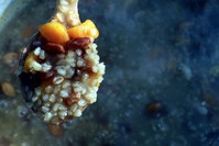 Coarsely ground wheat, chickpeas, beans, rice, apricots, grapes, berries, plums, figs, peanuts, orange peel and apples or pears are added into ashura.