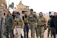 YPG militants and U.S. troops are seen during a patrol near the Turkish border in Hasakah, Syria, Nov. 4.