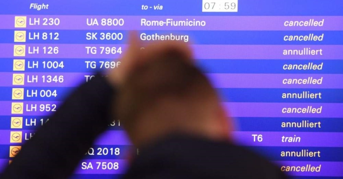 A passenger stands in front of the departure board at the airport in Frankfurt, Germany, Friday, Nov. 25, 2016. (AP Photo)