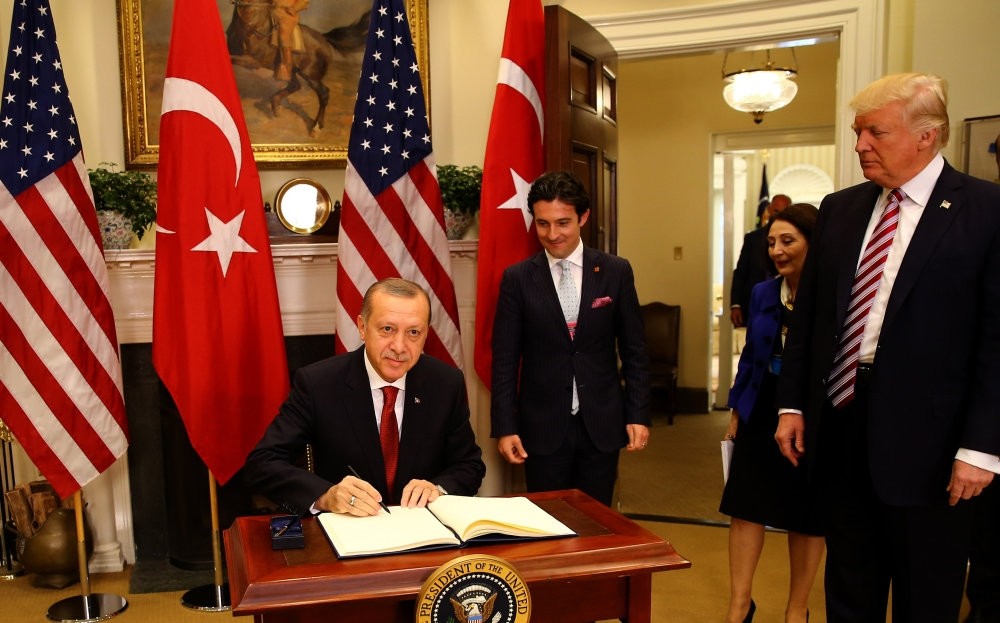 President Erdou011fan signs on the U.S. guest book in the Oval office of the White House during his first visit to Washington since Donald Trump became the president, May 16. 