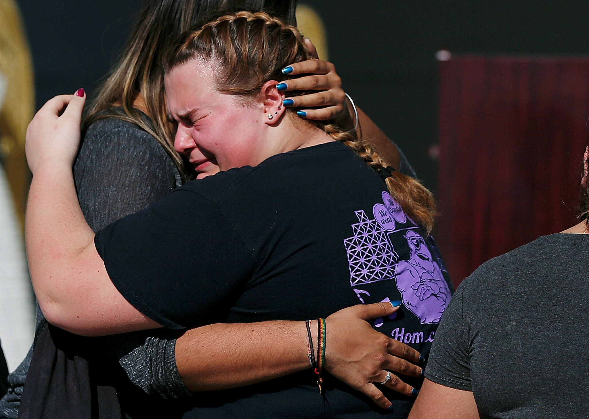 Kieran Ahearn, right, cries on the shoulder of her friend, Lara Bortolotti, left, during a community vigil at Pine Trails Park, Thursday, Feb. 15, 2018, in Parkland, for the victims of the shooting at Marjory Stoneman Douglas High School. (AP Photo)