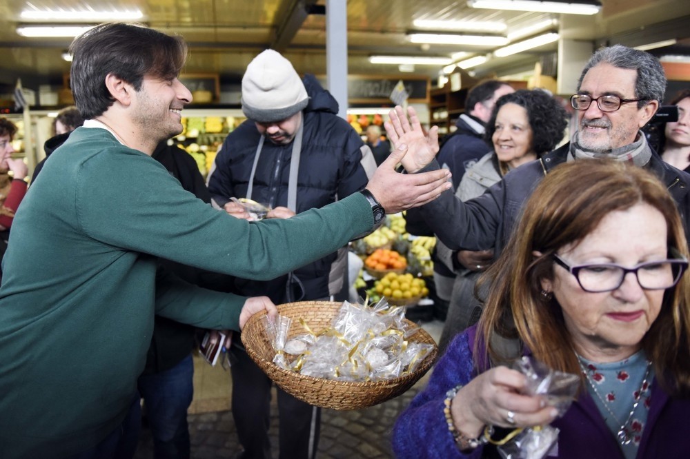 Syrian Ahmed Ahjam hands out samples of his work at the opening of his Middle Eastern pastry shop at the Mercado Agricola in Montevideo, Uruguay, Aug. 13.