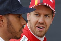 Ferrari driver Sebastian Vettel of Germany, (R), looks at Mercedes driver Lewis Hamilton of Britain after the qualifying session for the British Formula One Grand Prix.