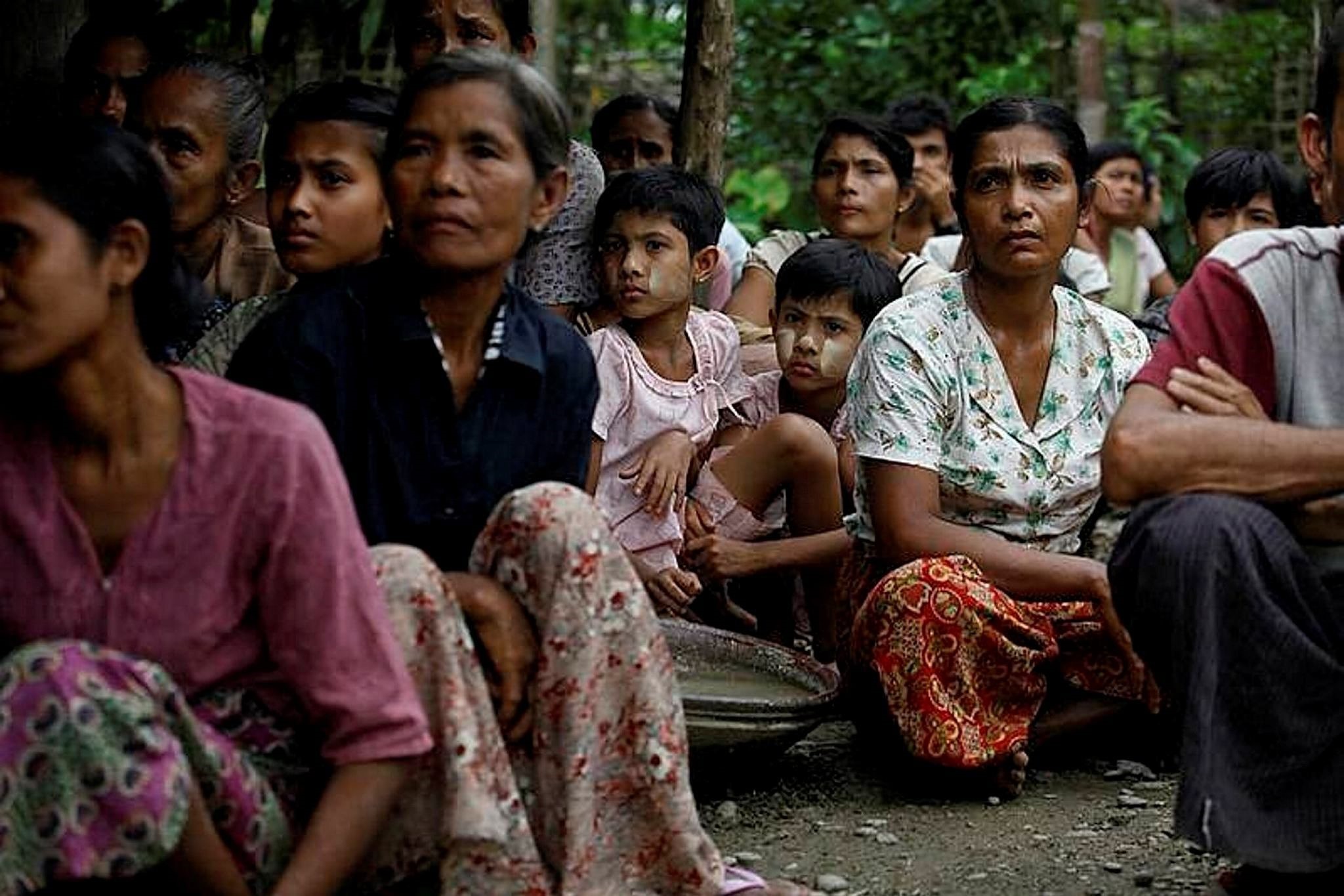Rohingya Muslums sit in a temporary refugee camp after losing their homes during the violence in the Rakhine state.