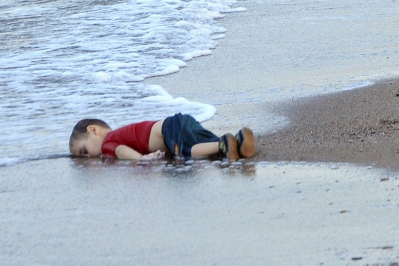 The washed up body of Aylan Kurdi, a refugee child who drowned during a failed attempt to sail to the Greek island of Kos, at the shore in the coastal town of Bodrum, Turkey. (EPA Photo)