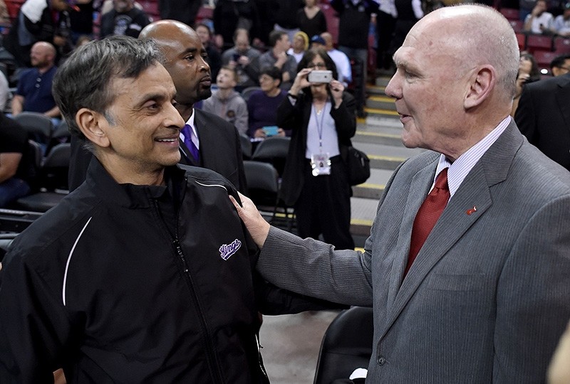 In this file photo taken on Feb. 20, 2015, head coach George Karl of the Sacramento Kings (R) gets greeted by the owner Vivek Ranadive (L) prior to the start of the game against the Boston Celtics in Sacramento, California. (AFP Photo)