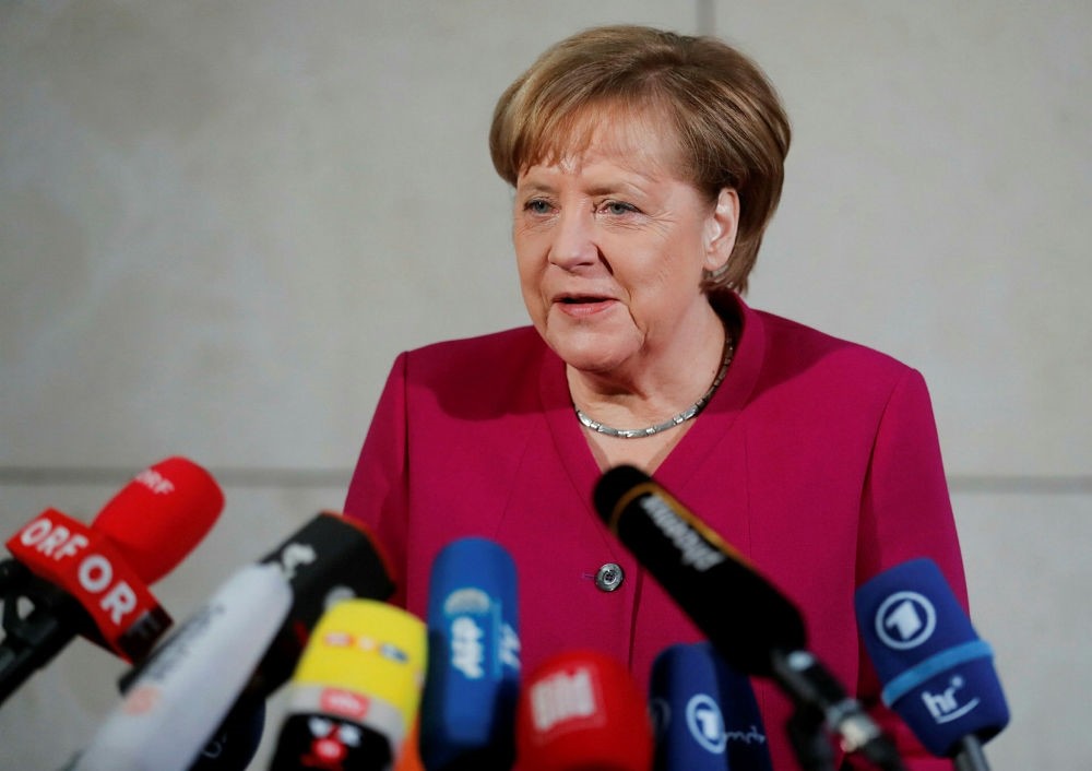 German Chancellor Angela Merkel delivers a speech before exploratory talks on forming a new coalition government at SPD headquarters, Berlin, Jan. 7.
