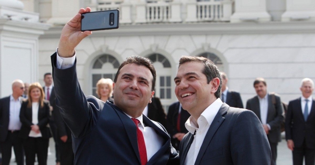 North Macedonia Prime Minister Zoran Zaev, left, takes a selfie with his Greek counterpart Alexis Tsipras, outside the Prime Minister office in Skopje, North Macedonia, on Tuesday, April 2, 2019. (AP Photo)