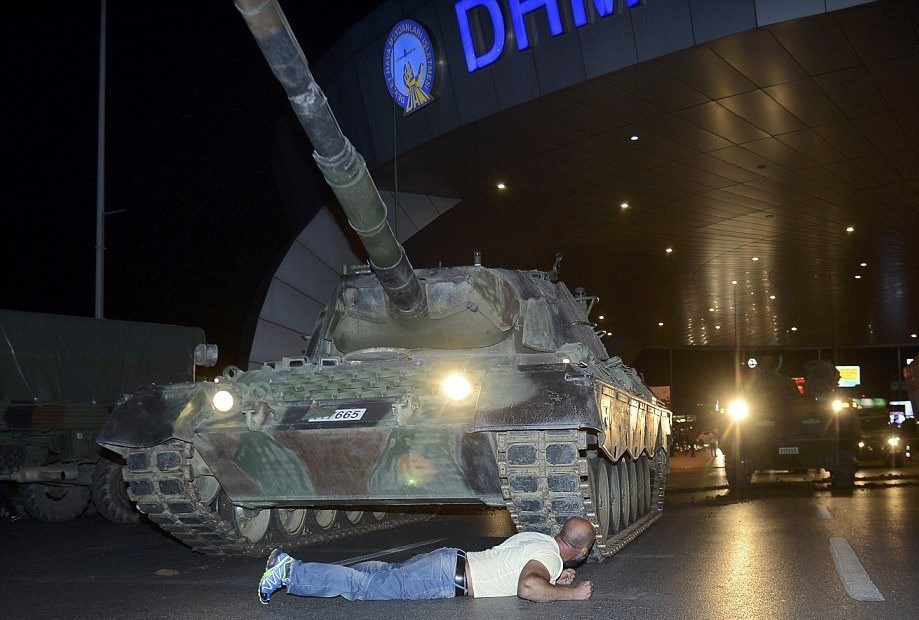 Metin Dou011fan lies before a tank on July 15, 2016.