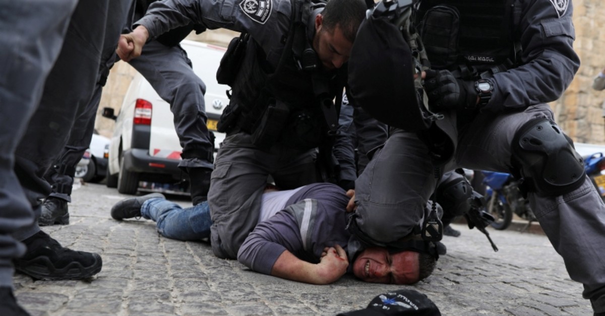 Israeli police officers detain a Palestinian protestor during scuffles outside the compound housing al-Aqsa Mosque in Jerusalem's Old City March 12, 2019. (Reuters Photo)