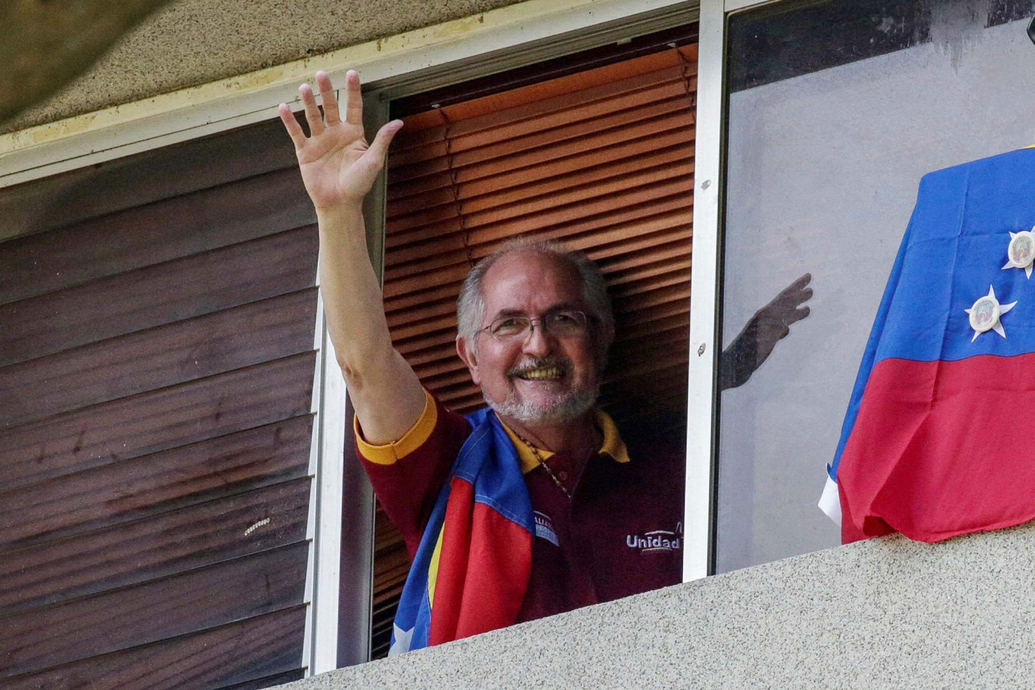 Antonio Ledezma, Metropolitan Mayor of Caracas, waves from a window of his residence in Caracas, Venezuela, 16 July 2017 (EPA File Photo)