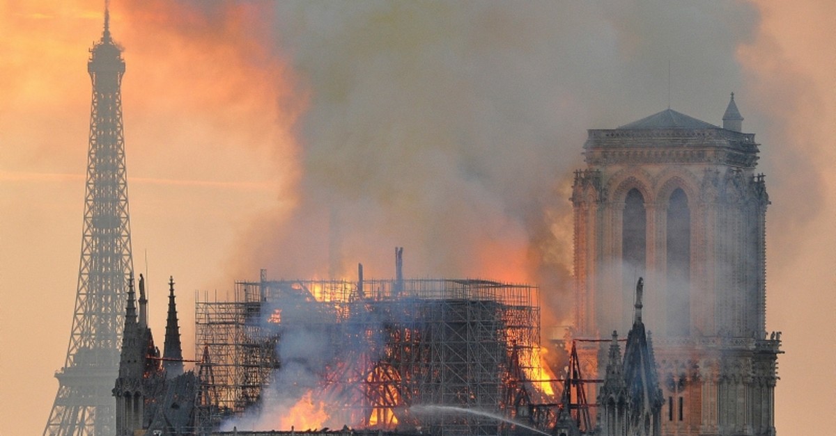 In this image made available on Tuesday April 16, 2019 flames and smoke rise from the blaze after the spire toppled over on Notre Dame cathedral in Paris, Monday, April 15, 2019. (AP Photo)