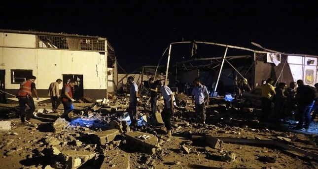 Emergency workers and others recover bodies after an airstrike east of Tripoli, July 3, 2019. (AFP Photo)