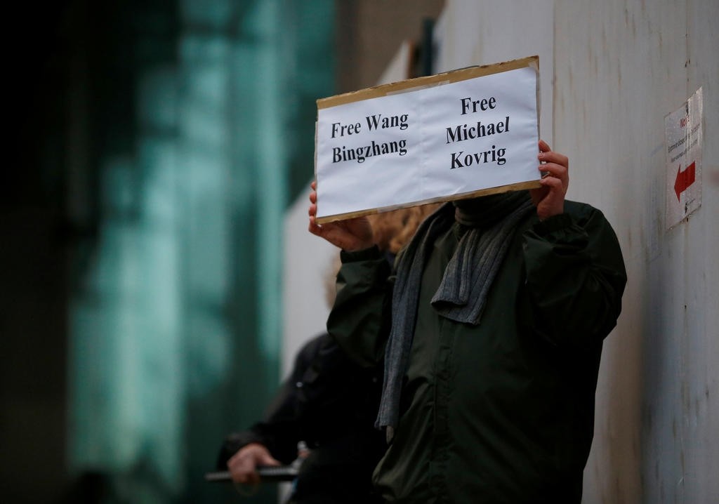 A man holds a sign calling for China to release Wang Bingzhang and former Canadian diplomat Michael Kovrig, who was arrested in China on Tuesday. (REUTERS Photo)