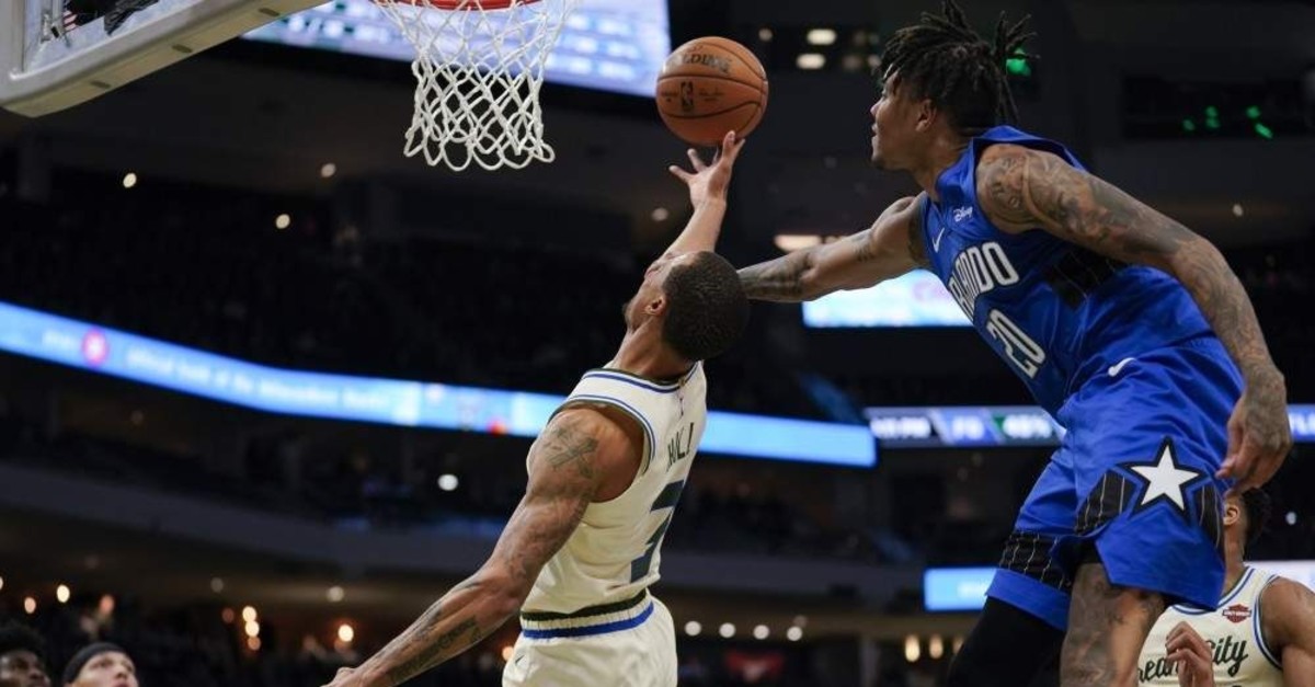 Orlando Magic's Markelle Fultz fouls Milwaukee Bucks' George Hill as he shoots during the second half of the game, Milwaukee, Dec. 9, 2019. (AP Photo)