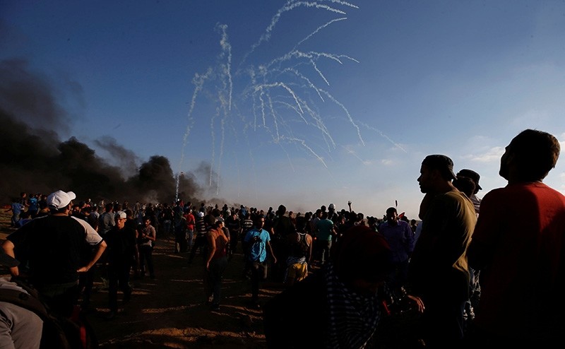 Tear gas canisters are fired by Israeli troops toward Palestinian demonstrators during a protest demanding the right to return to their homeland at the Israel-Gaza border, in Gaza Aug. 17, 2018. (Reuters Photo)