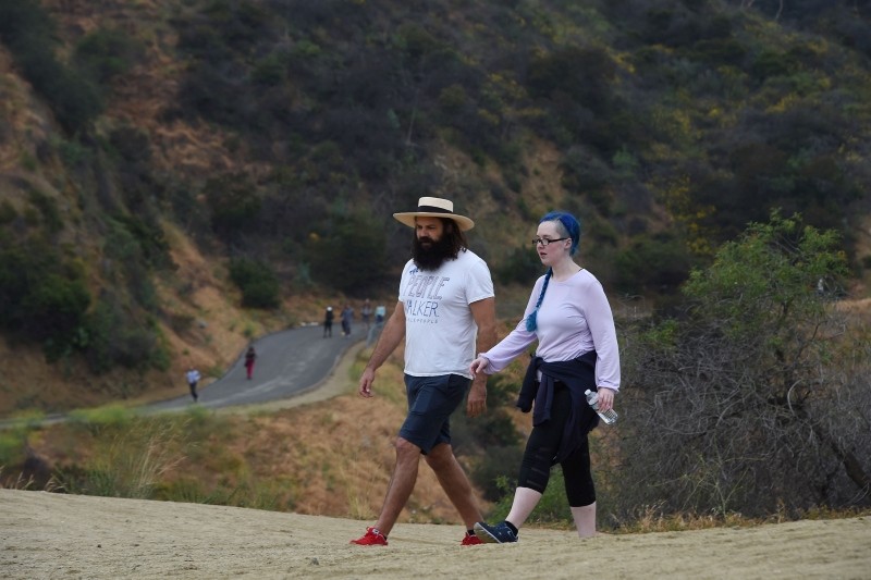 Chuck McCarthy chats with his client Anie Dee (R) as they walk in the Hollywood Hills, May 24, 2018 in Runyon Canyon Park in Los Angeles, California (AFP Photo)