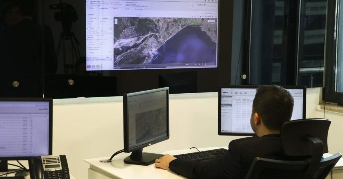 A surveillance center employee watches the screen where movements of people fitted with electronic bracelets are shown, Ankara, Jan. 3, 2020. (DHA Photo)