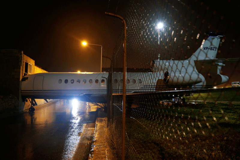 A privately-owned Dassault Falcon 7X business jet aircraft is seen after it was blown off the airport apron and into an adjacent building as strong winds hit the Maltese islands, according to local media (Reuters Photo)