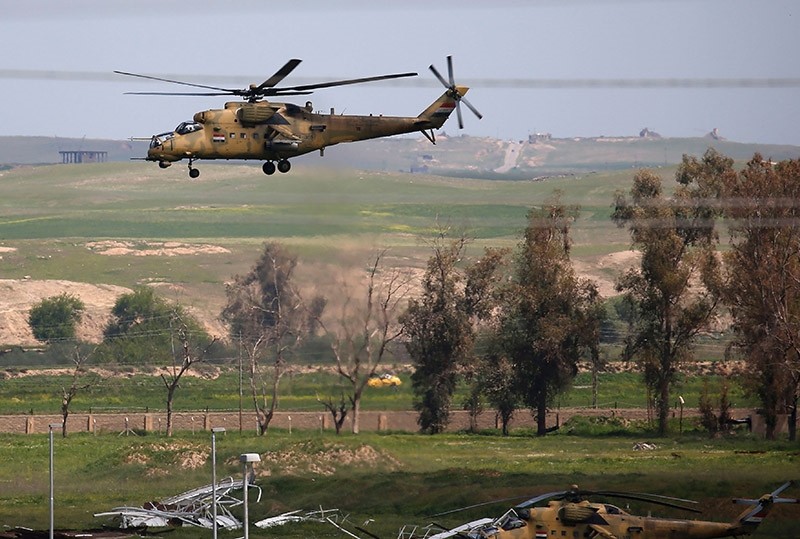 Iraqi army helicopters are seen on the outskirts of western Mosul on April 6, 2017 (AFP Photo)