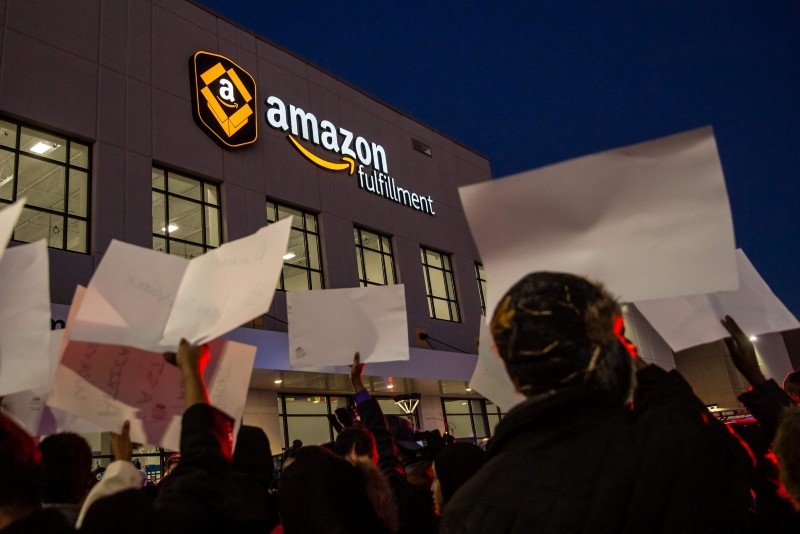 Demonstrators shout slogans and hold placards during a protest at the Amazon fulfillment center in Shakopee, Minnesota, on Dec. 14, 2018.(AFP Photo)