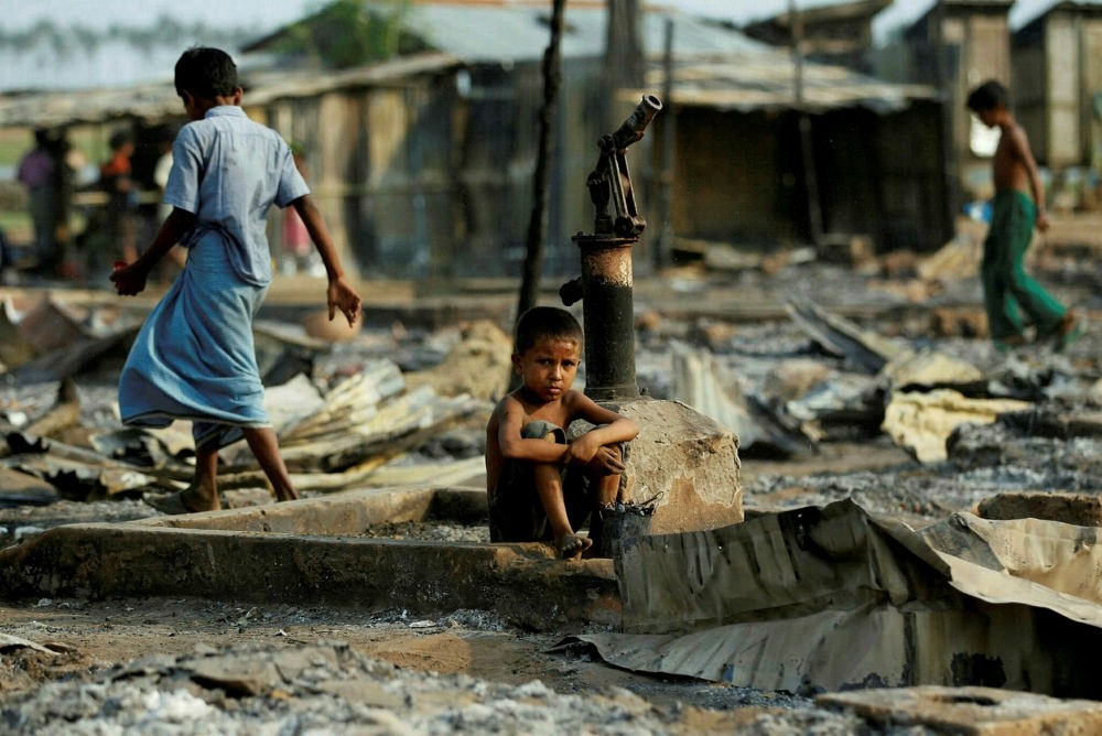 A boy sits in a burnt area after fire destroyed shelters at a camp for internally displaces Rohingya Muslims in the western Rakhine state, Myanmar.