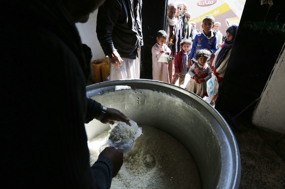 Conflict-ridden Yemenis receive local charity-provided food rations in Sana'a, Yemen, Nov. 12.