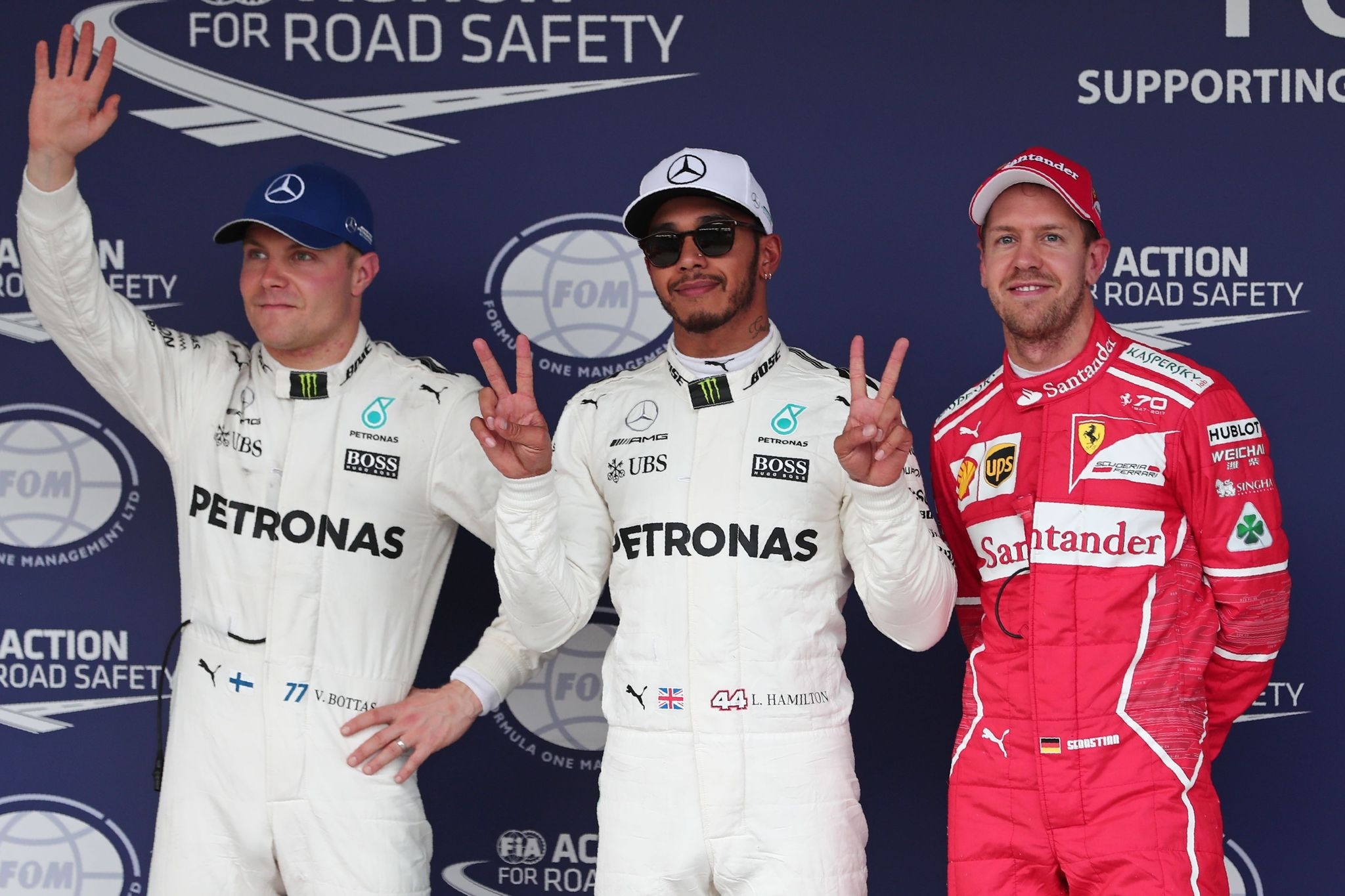 Hamilton, (C) poses with Valtteri Bottas (L) and Sebastian Vettel after getting pole position for the Japanese Formula 1 Grand Prix at Suzuka Circuit, Oct. 7, 2017. (AP Photo)