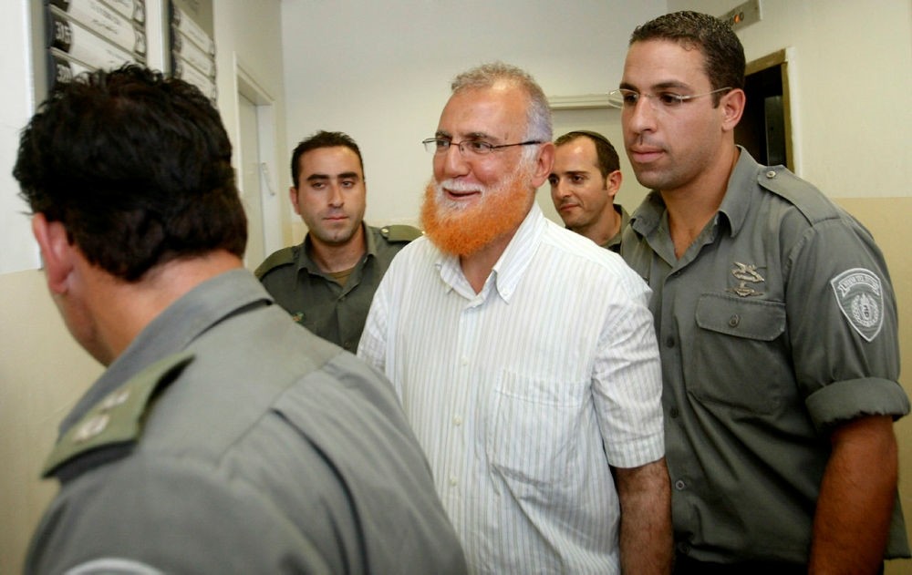 Palestinian lawmaker Mohammed Abu Teir, center, is escorted into a courtroom  in Jerusalem, Monday, July 12, 2010. (AP Photo)