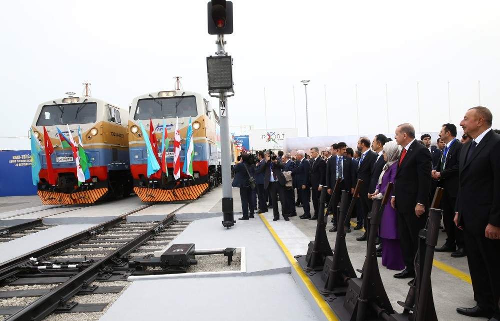 Erdou011fan (2nd R), accompanied by first lady Emine Erdou011fan (3rd R), Azerbaijan's Aliyev (R), Kazakh, Uzbek and Georgian leaders and their delegations look at trains during the inauguration ceremony of the Baku-Tbilisi-Kars Railway, Baku, Oct. 30.