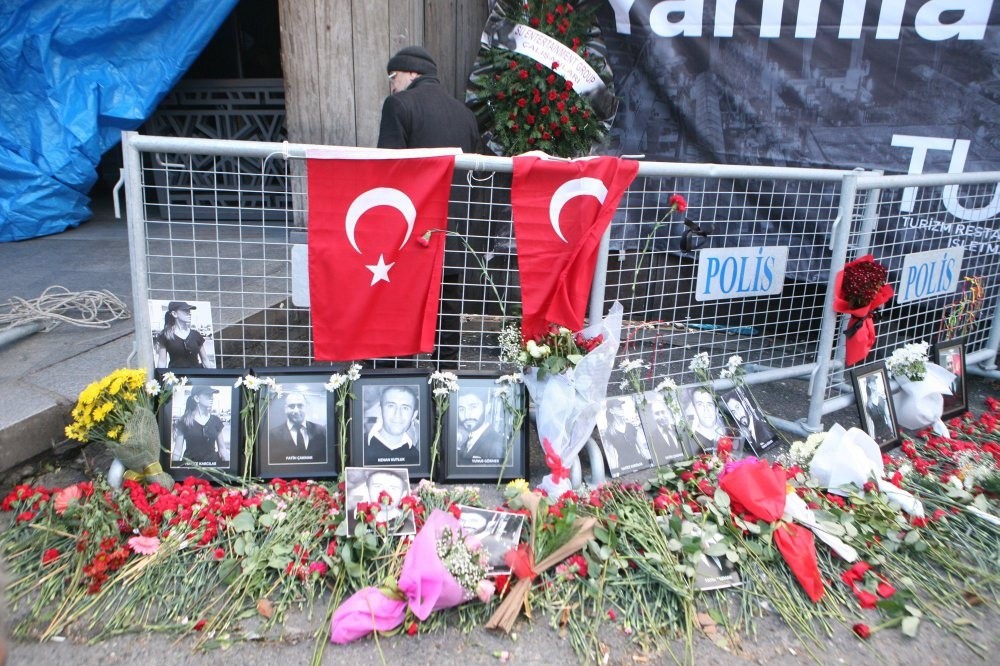 Flowers, Turkish flags and photos of victims on and around police barriers outside the Reina nightclub.