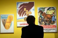 A visitor at the ,Saving: History of a German Virtue, exhibition.