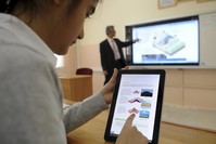 A student is introduced to the Fatih project in the classroom with a laptop. At the fair, the ministry of education had an exhibition to present the Fatih Project to the rest of the world.