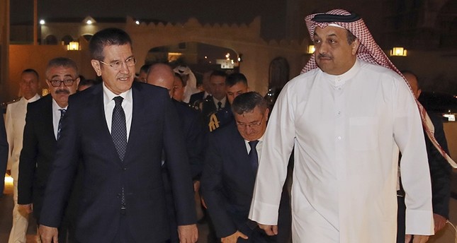 Turkey's Defence Minister Nurettin Canikli, left, walks with his Qatar's counterpart Khalid bin Mohammed al-Attiyah, right, following their meeting in Doha, Qatar, Saturday, Nov. 4, 2017. (AP Photo)