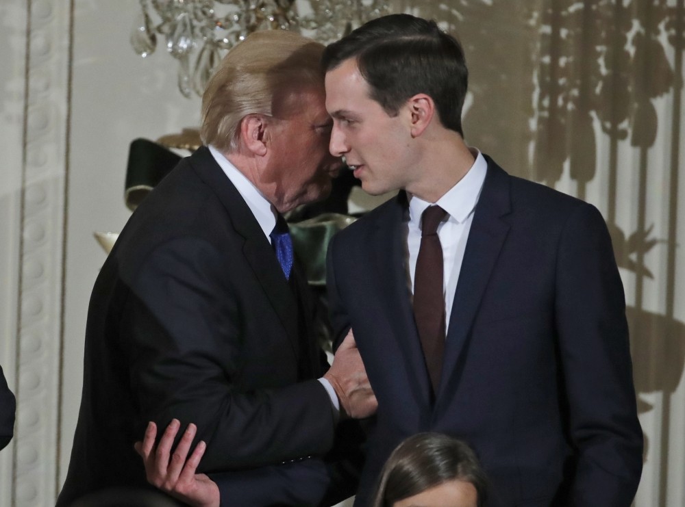 U.S. President Donald Trump speaks with White House Senior Adviser Jared Kushner as he departs after a reception in the White House.