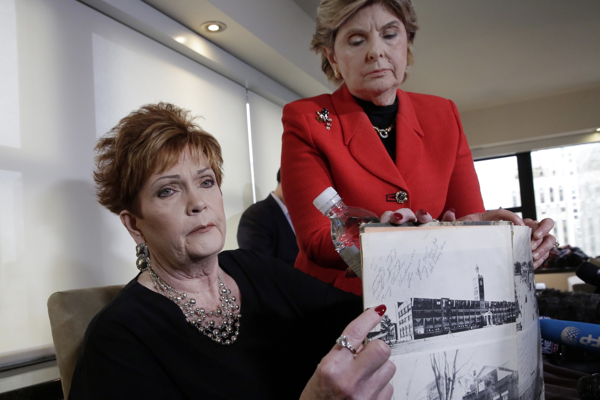 Beverly Young Nelson, left, and attorney Gloria Allred hold Nelson's high school yearbook, signed by Roy Moore, at a news conference, in New York, Monday, Nov. 13, 2017. (AP Photo)