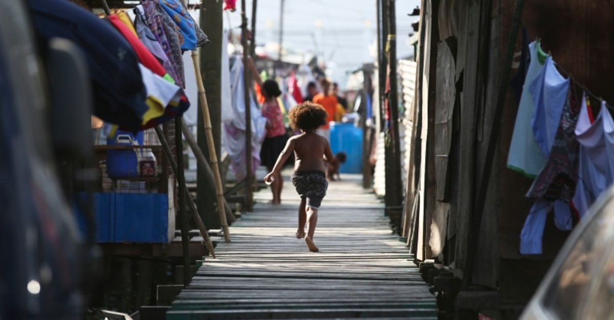 In this Nov. 15, 2018, file photo, a girl runs towards their home at Port Moresby, Papua New Guinea (AP File Photo)