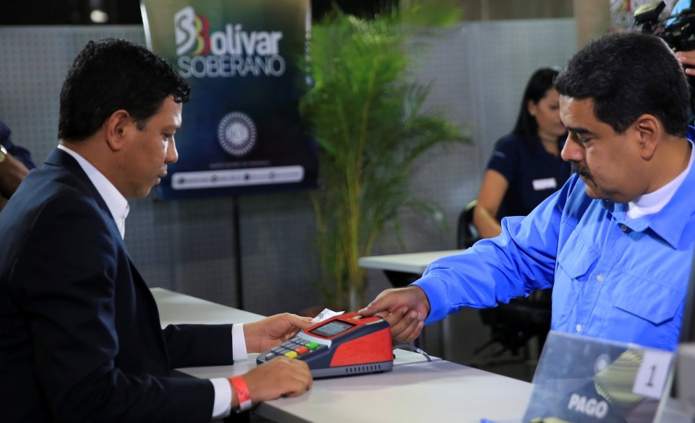 Venezuela's President Nicolas Maduro participates in the process of buying a savings certificate in gold at Venezuela's Central Bank in Caracas, Sept. 3.