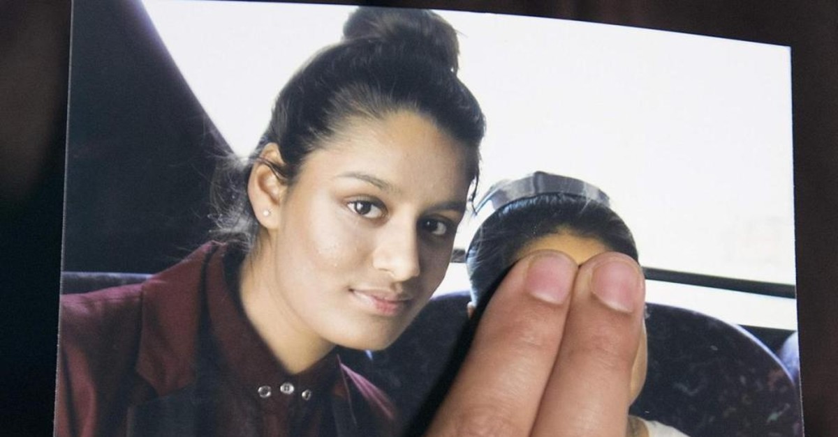 Renu Begum, eldest sister of missing 19-year-old UK girl Shamima Begum, holds a picture of her sister taken with another girl, whose face is covered in the photo to protect her identity, while being interviewed by the media in London, Feb. 22, 2015