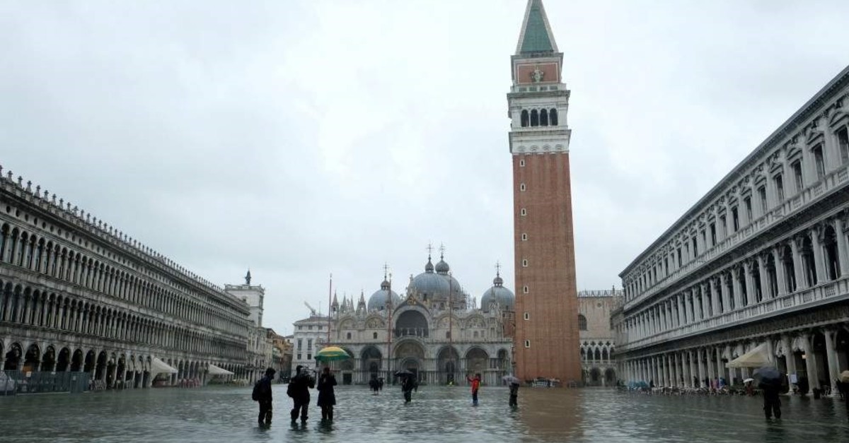 People wade through a flooded St. Mark's Square during a period of seasonal high water, Venice, Nov. 24, 2019. (REUTERS Photo)
