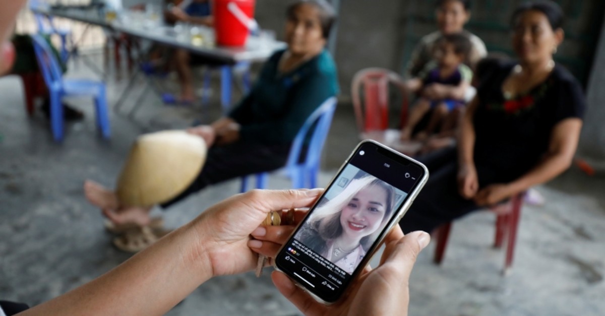 A relative looks at an image of Anna Bui Thi Nhung, a Vietnamese suspected victim in a truck container in UK, at her home in Nghe An province, Vietnam Oct. 26, 2019 (Reuters Photo)