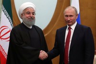 Iranian President Hassan Rouhani (L) shakes hands with Russian President Vladimir Putin (R) during a meeting in the Black sea resort city of Sochi, Russia, Nov. 22, 2017