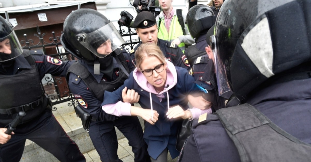 Police officers detain an opposition candidate and lawyer at the Foundation for Fighting Corruption Lyubov Sobol in the center of Moscow, Russia, Saturday, Aug. 3, 2019. (AP Photo)